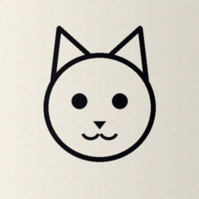 A phone picture of a pen drawing of a cat's face on paper, with uneven light